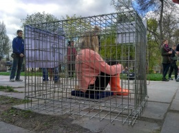 Запорожанка приковала себя цепью к клетке в центре города (Фото)
