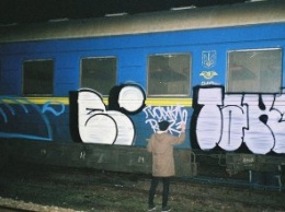 В Днепре группа людей в балаклавах остановила пригородный поезд, чтобы разрисовать вагоны граффити