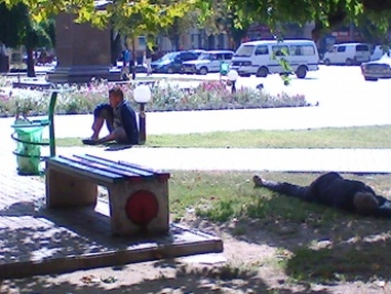 Двое мужчин весь день спят на газоне в центре города. Полиция их будить не спешит (фото)
