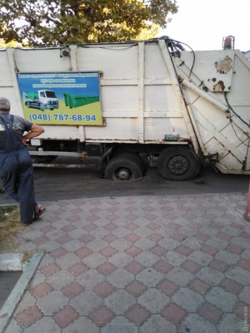 В Черноморске мусоровоз продавил асфальт и провалился колесом в ливневку