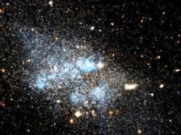 Ученые показали на снимках Hubble развалившуюся карликовую галактику