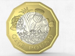 В Великобритании выпустили в обращение новые 12-гранные монеты номиналом 1 фунт